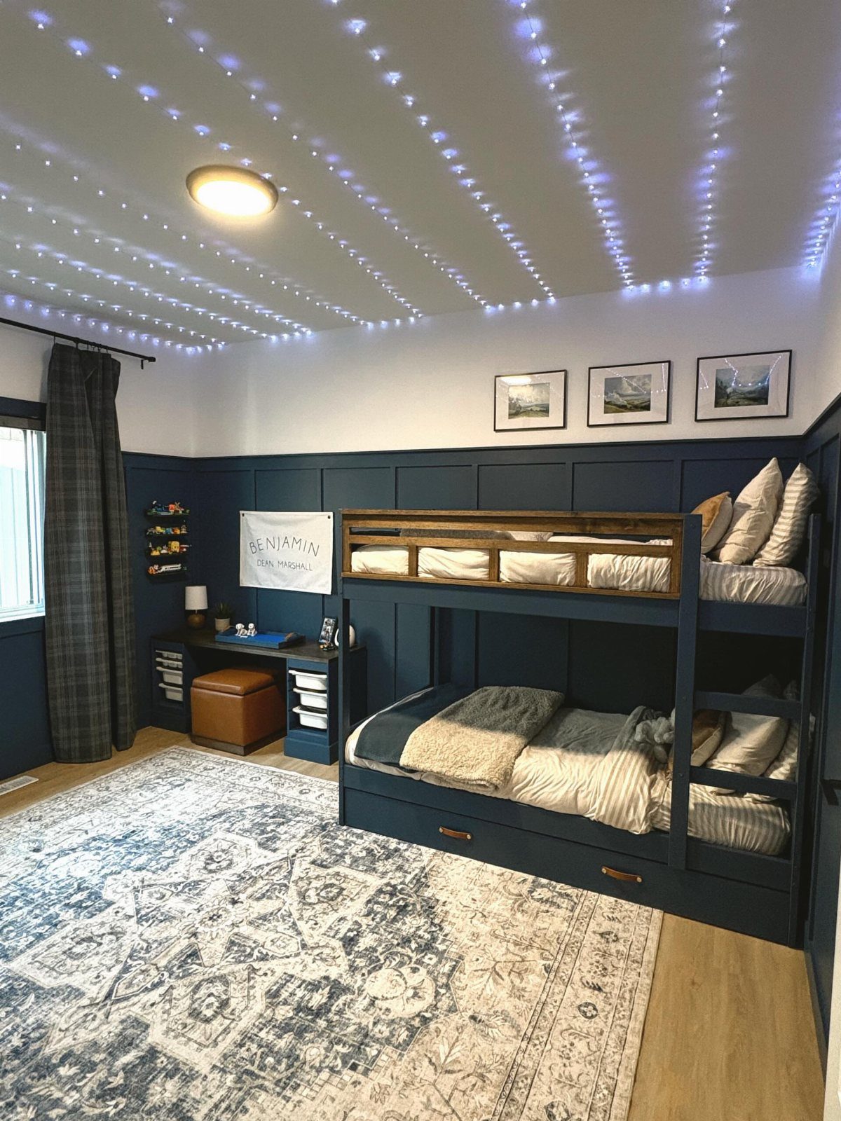 Boys Bedroom Ideas with Bunk Beds: 12 Layouts That Work 5 Navy-blue bunk bed with built-in storage drawers in a bedroom with starry ceiling lights.